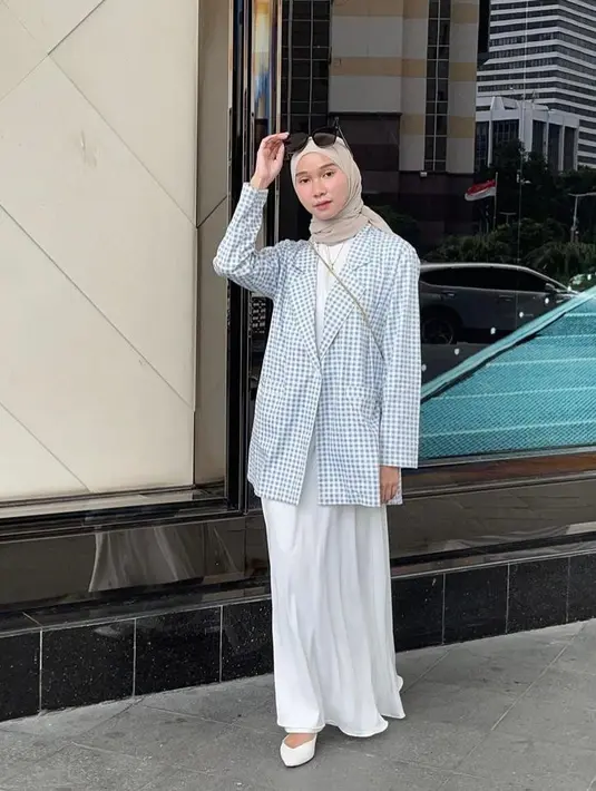 Kombinasi outfit warna putih dan biru pastel dengan hijab warna beige bikin tampilan yang lembut dan feminin. (Instagram/nasariastri).