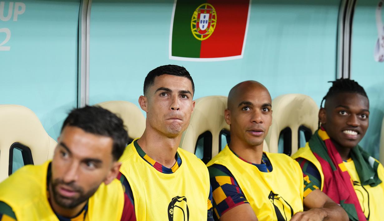 <p>Pemain Portugal, Cristiano Ronaldo (kiri kedua) terlihat duduk di bangku cadangan saat laga 16 besar Piala Dunia 2022 melawan Swiss yang berlangsung di Lusail Stadium, Selasa (06/12/2022) waktu setempat. (AP/Natacha Pisarenko)</p>