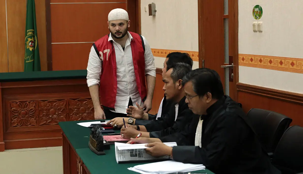 Sama seperti sidang sebelumnya, Ridho turun dari mobil bersama tahanan lain berjalan menunduk memasuki ruang sidang. Tak ada kata terucap dari penyanyi dangdut itu. (Deki Prayoga/Bintang.com)