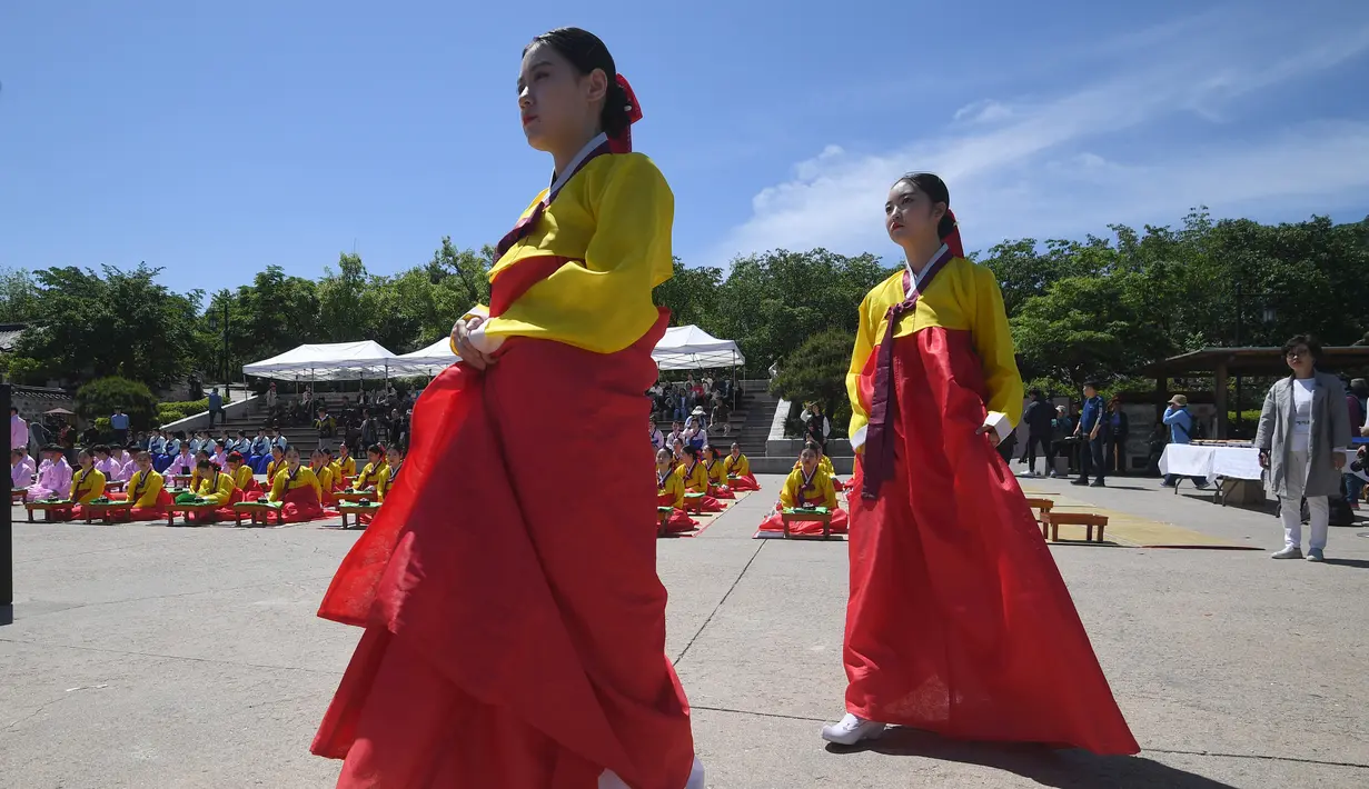 Dua gadis Korea Selatan mengenakan busana tradisional saat mengikuti upacara Coming of Age Day di desa Hanan Namsan di Seoul (21/5). (AFP Photo/Jung Yeon-je)