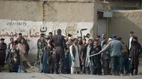 Sejumlah warga berkumpul di dekat lokasi serangan bom mobil bunuh diri yang menargetkan tentara asing di Kabul, (2/3). Ledakan menewaskan satu orang dan melukai empat lainnya. (AFP Photo/Wakil Kohsar)