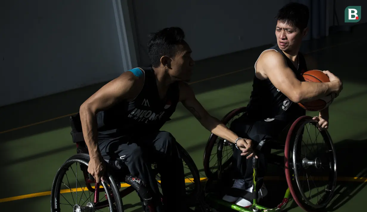Pebasket kursi roda Indonesia, Edy Johan, berebut bola dengan Gusti Adnyana saat latihan di Lapangan basket Istana Kana, Jakarta Pusat, Senin (17/9/2018). Tim basket kursi roda Indonesia bersiap hadapi Asian Para Games. (Bola.com/Vitalis Yogi Trisna)
