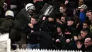 Suporter Ajax Amsterdam bentrok dengan polisi anti huru-hara Yunani sebelum pertandingan Liga Champions melawan AEK Athena di Stadion Olimpiade Athena, Selasa (27/11). Lemparan bom molotov juga mewarnai kerusuhan di stadion itu. (Aris Messinis/AFP)