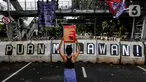 Salah seorang aktivis perempuan saat melakukan unjuk rasa memperingati Hari Perempuan Internasional di kawasan Patung Kuda, Jakarta, Jumat (8/4/2024). (Liputan6.com/Angga Yuniar)