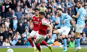 Pemain Manchester City, Rayan Cherki, mencetak gol pertama timnya dalam pertandingan Liga Inggris melawan Arsenal di Etihad Stadium, Minggu (19/4/2026) malam WIB. (AP Photo/Dave Thompson)