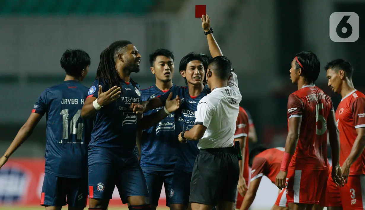 Wasit memberikan kartu merah kepada pemain Arema FC saat melawan PSM Makassar pada pertandingan BRI Liga 1 2021 di Stadion Pakansari, Bogor, Minggu (5/9/2021). PSM Makassar bermain imbang atas Arema FC 1-1. (Bola.com/M Iqbal Ichsan)