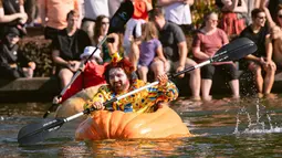 Kevin Bailey, dari Tualatin, mengayuh labu raksasa dalam final leg saat event West Coast Giant Pumpkin Regatta di Tualatin, Oregon, Amerika Serikat pada 16 Oktober 2022. Kegiatan yang digelar sejak 2004 tersebut menjadi daya tarik sebagai hiburan masyarakat sekitar. (Photo by Wesley Lapointe / AFP)