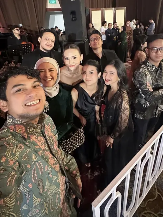 Adinda Azani mengenakan dress hitam dengan aksen model outer lace. Tampil dengan lipstik merah merona. [@dindazani]