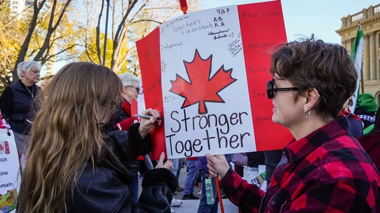 Seorang peserta aksi menuliskan pesan pada poster saat mengikuti demonstrasi mendukung Alberta tetap menjadi bagian dari Kanada di Edmonton, Provinsi Alberta, Minggu (18/10/2026).