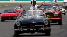 Pembalap Formula 1 Mercedes asal Jerman, Nico Rosberg menyapa pengemar saat duduk di atas mobil Mercedes-Benz klasik saat mengikuti parade jelang Grand Prix Formula 1 Malaysia di Sirkuit Internasional Sepang, Malaysia, (2/10). (REUTERS/Edgar Su)