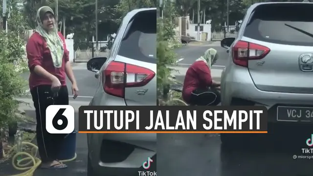 Perekam yang hendak lewat dengan mobilnya nampak protes namun tak diindahkan.