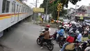 Kereta melintas di kawasan Lenteng Agung, Jakarta, Selasa (13/3). Untuk mengurai kemacetan imbas antrian kendaraan berputar balik di pintu kereta IISIP, Pemprov DKI berencana membangun flyover U-Turn di kawasan tersebut. (Liputan6.com/Immanuel Antonius)