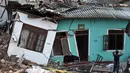 Warga Sri Lanka mengamati rumahnya yang rusak tertimbun gundukan sampah yang longsor di Meetotamulla, dekat ibukota Kolombo, Minggu (16/4). Sedikitnya 23 orang tewas akibat tanah longsor di tempat pembuangan sampah tersebut. (ISHARA S. KODIKARA/AFP)