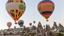 <p>Sejumlah balon udara panas yang membawa wisatawan terbang di atas Nevsehir di wilayah Cappadocia, Turki (5/9). (AFP Photo/Yasin Akgul)</p>