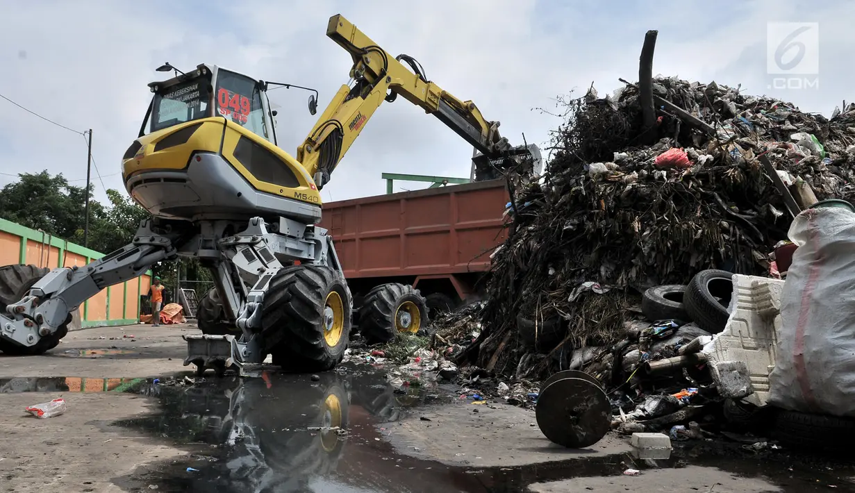 Alat berat mengangkut sampah di area proyek Fasilitas Pengolahan Sampah Terpadu atau Intermediate Treatment Facility (ITF) Sunter, Jakarta, Selasa (12/2). Hingga kini ITF Sunter belum dimulai pembangunannya. (Merdeka.com/Iqbal Nugroho)