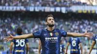 Gelandang Inter Milan, Hakan Calhanoglu berselebrasi usai mencetak gol ke gawang Genoa pada pertandingan perdana Liga Serie A Italia di stadion San Siro di Milan, Italia, Sabtu (21/8/2021). Inter Milan menang telak atas Genoa dengan skor 4-0. (Spada/LaPresse via AP)