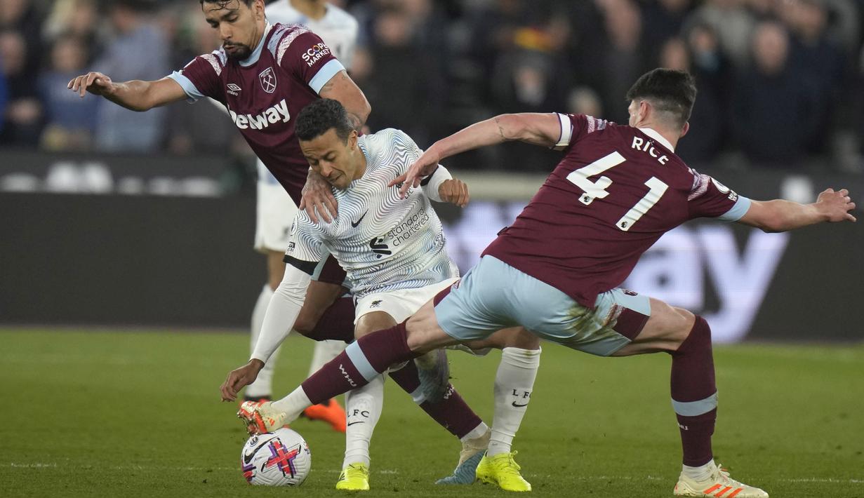 Pemain Liverpool, Thiago, diadang pemain West Ham United, Declan Rice dan Lucas Paqueta pada pekan ke-33 Liga Inggris 2022/2023, Kamis (27/4/2023). Liverpool menang dengan skor 2-1. (AP Photo/Alastair Grant)