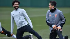 Penyerang Liverpool, Mohamed Salah (kiri) dan Roberto Firmino melakukan pemanasan saat latihan di Melwood Training Ground, Liverpool, Inggris (5/3). Liverpool akan melawan Porto pada leg kedua babak 16 besar Liga Champions. (AFP Photo/Anthony Devlin)