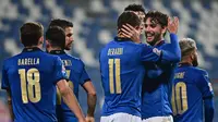 Striker Italia, Domenico Berardi (11), merayakan gol kedua Italia yang dicetaknya, bersama Manuel Locatelli dalam laga UEFA Nations League Grup A1 melawan Polandia di Stadion Mapei, Italia, Senin (16/11/2020) dini hari WIB. Italia menang 2-0 atas Polandia. (AFP/Miguel Medina)
