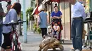 Mitani Hisao dan Bon-chan selalu menjadi pusat perhatian ketika mereka jalan berkeliling sekitar Tokyo. (AFP Photo/Kazuhiro Nogi)