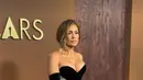 Jennifer Lopez terlihat glamor dengan tube dress hitam yang pas di tubuhnya dari Tamara Ralph. Dipadu dengan aksen train satin dan suede glove [@theacademy]
