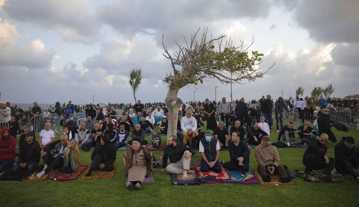 Umat muslim berkumpul untuk melaksanakan salat Idul Fitri yang menandai berakahirnya bulan suci Ramadan di sebuah taman di Jaffa, Israel, Minggu (24/5/2020). Jaffa merupakan kota campuran Yahudi-Arab. (AP Photo/Oded Balilty)