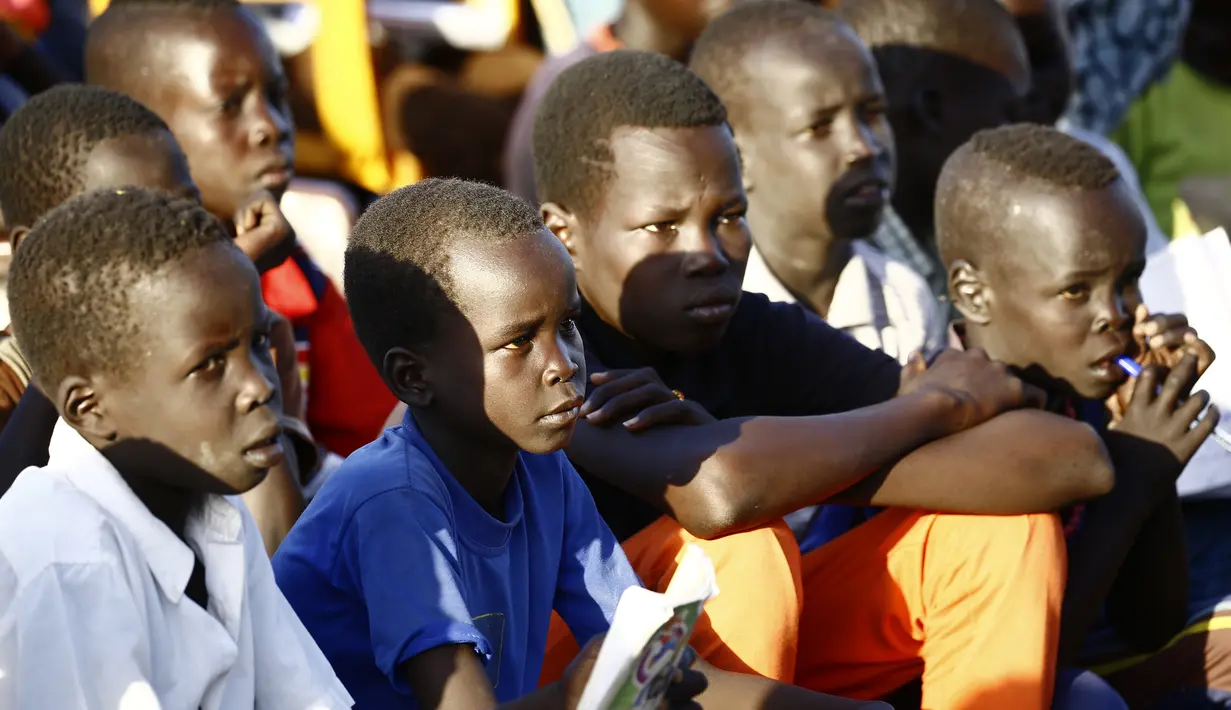 Anak-anak mengikuti pelajaran membaca di kamp UNHCR al-Algaya di negara bagian Nil Putih Sudan, selatan Khartoum, (17/5). PBB mengatakan ribuan orang terus melarikan diri dari perang dan kelaparan di negara termuda di dunia ini. (AFP Photo/Ashraf Shazly)