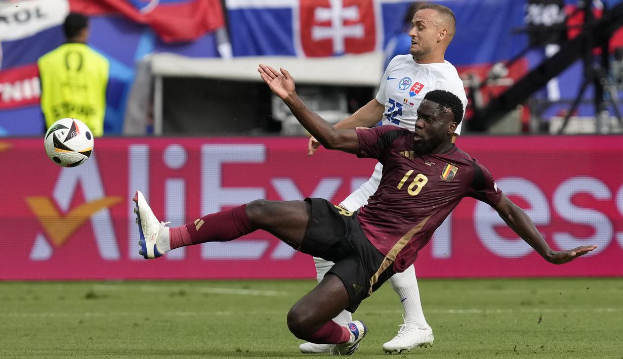 Gelandang Timnas Belgia, Oriel Mangala (depan) berusaha memotong bola umpan yang dilepaskan gelandang Timnas Slovakia, Stanislav Lobotka pada laga Grup E Euro 2024 di Waldstadion, Frankfurt, Jerman, Senin (17/6/2024). (AP Photo/Darko Vojinovic)
