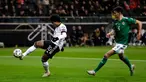 Gelandang Timnas Jerman, Serge Gnabry mengontrol bola dengan dibayangi pemain Irlandia Utara pada laga Grup C Kualifikasi Piala Eropa 2020 di Commerzbank Arena, Selasa (19/11/2019). Timnas Jerman benamkan Irlandia Utara dengan skor telak 6-1 berkat bantuan hat-trick dari Gnabry. (AP/Michael Probst)
