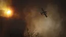 Sebuah pesawat menjatuhkan air saat terjadi kebakaran di Cordoba, Argentina, Senin (12/10/2020). Kebakaran hutan telah menghancurkan ribuan hektare di Provinsi Cordoba tahun ini, di tengah kekeringan dan suhu tinggi. (AP Photo/Nicolas Aguilera)