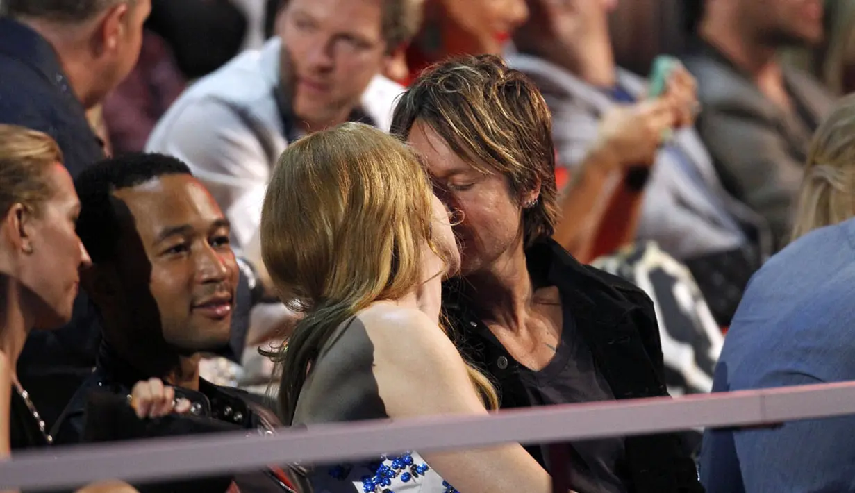 Nicole Kidman dan suaminya Keith Urban memamerkan kemesraan mereka dengan berciuman saat menyaksikan ajang CMT Music Awards 2014 di Bridgestone Arena, Nashville, Tennessee, (4/6/2014). (REUTERS/Harrison McClary)