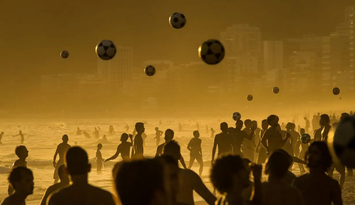 Orang-orang bermain sepak bola saat matahari terbenam di Pantai Ipanema di Rio de Janeiro, Brazil (AFP PHOTO/Yasuyoshi CHIBA)