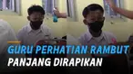 Momen tidak terduga terjadi ketika seorang siswa memiliki rambut panjang dan dirapikan oleh gurunya.
