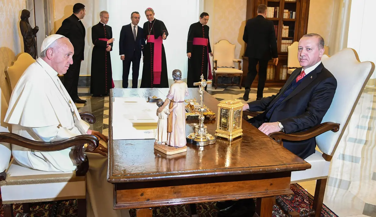 Presiden Turki Erdogan berbincang dengan Paus Fransiskus saat kunjungannya ke Vatikan (5/2). Pertemuan itu juga membahas perkembangan di Timur Tengah, khususnya Suriah, terorisme serta dialog antar-agama. (Alessandro Di Meo / Pool via AP)