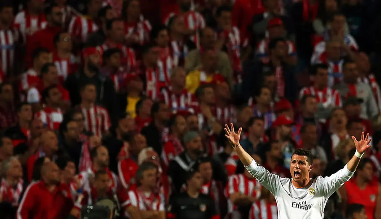 Ekspresi bintang Real Madrid, Cristiano Ronaldo dengan latar suporter Atletico Madrid pada laga final Liga Champions di Stadion Luz, Portugal, Sabtu (24/5/2014). (EPA/Jose Sena Goulao)