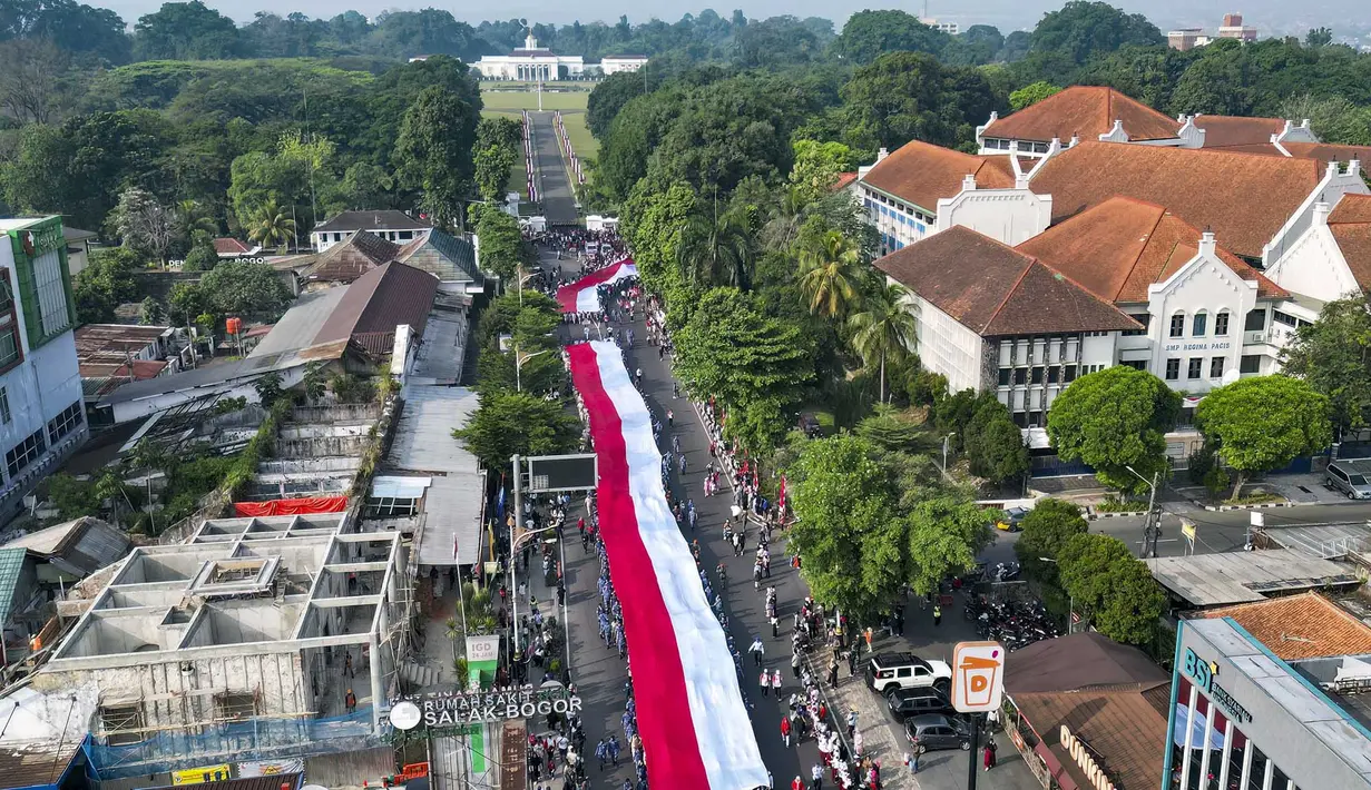 Foto udara ini memperlihatkan sekitar 3.500 orang yang berpartisipasi dalam pawai membawa bendera Indonesia sepanjang 500 meter di Jalan Sudirman Bogor, Jawa Barat, Minggu,  9 Agustus 2026. (AFP/ Aditya Aji)