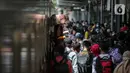 <p>Pemudik menunggu giliran untuk naik ke dalam kereta tujuan mereka di Stasiun Pasar Senen, Jakarta, Selasa (26/4/2022). Sepekan menjelang Lebaran, lonjakan jumlah penumpang kereta api sudah mulai terlihat pada Selasa siang ini, dan diperkirakan akan terus bertambah hingga 30 April atau H-2 Idul Fitri. (Liputan6.com/Faizal Fanani)</p>