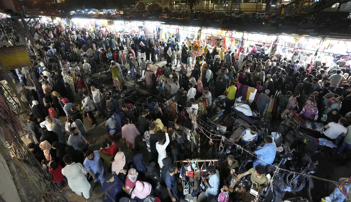 Orang-orang mengunjungi pasar untuk berbelanja untuk perayaan lebaran Idul Fitri 1444 Hijirah, di Karachi, Pakistan, Minggu, 16 April 2023. (AP Photo/Fareed Khan)