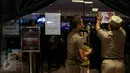 Anggota Satpol PP menempelkan kertas saat menyegel klinik Chiropractic First di mall Grand Indonesia, Jakarta, Rabu (13/1). Sembilan klinik Chiropractic First di sejumlah mall di Jakarta disegel karena tidak memiliki izin (Liputan6.com/Faizal Fanani)