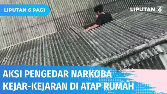 Detik-detik penggerebekan sarang peredaran narkoba di Kampung Bahari, Tanjung Priok. Pengedar narkoba kocar-kacir, salah satunya nekat kabur dan berlarian di atap rumah warga, akhirnya jatuh juga.