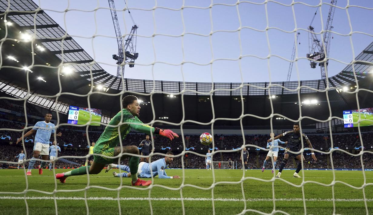 Striker Real Madrid, Rodrygo (kanan) mencetak gol ke gawang Manchester City pada laga leg kedua perempatfinal Liga Champions 2023/2024 di Etihad Stadium, Manchester, Rabu (18/4/2024). (PA via AP Photo/Martin Rickett)