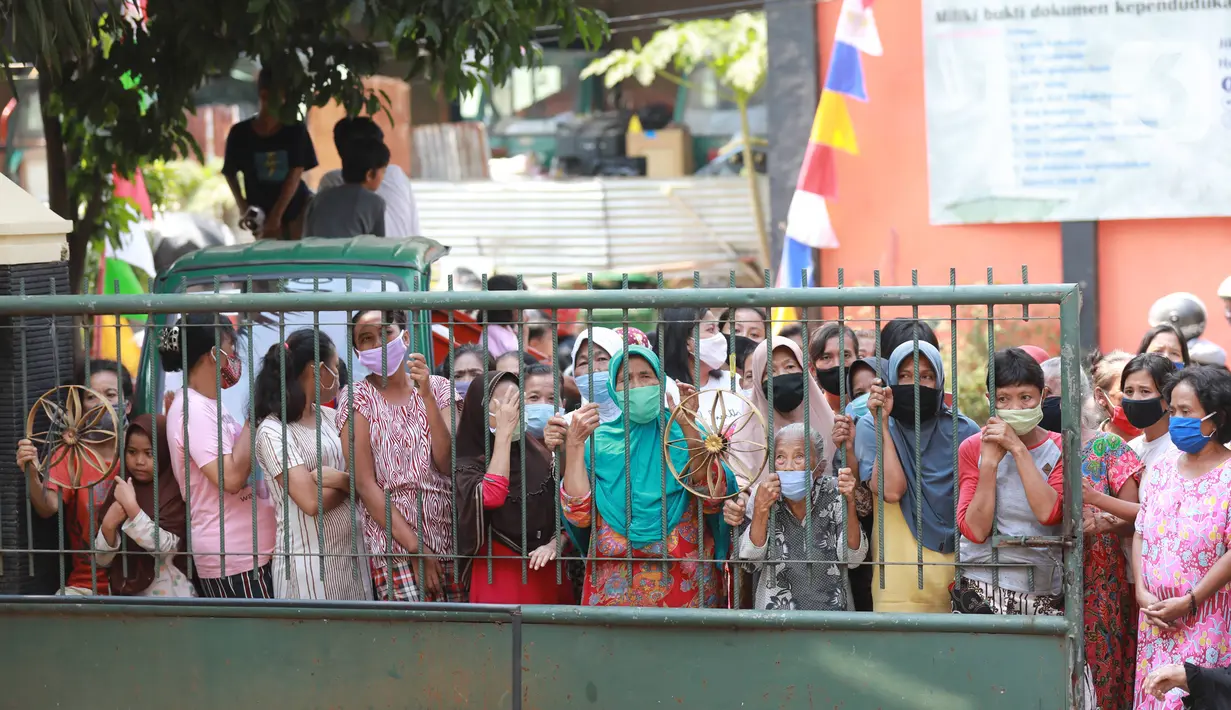 Warga antre menunggu untuk mendapatkan daging kurban di Kelurahan Menteng, Jakarta Pusat, Sabtu (1/8/2020). Pembagian daging kurban tersebut berjalan lancar meskipun sebagian warga mengabaikan protokol Kesehatan. (Liputan6.com/Angga Yuniar)