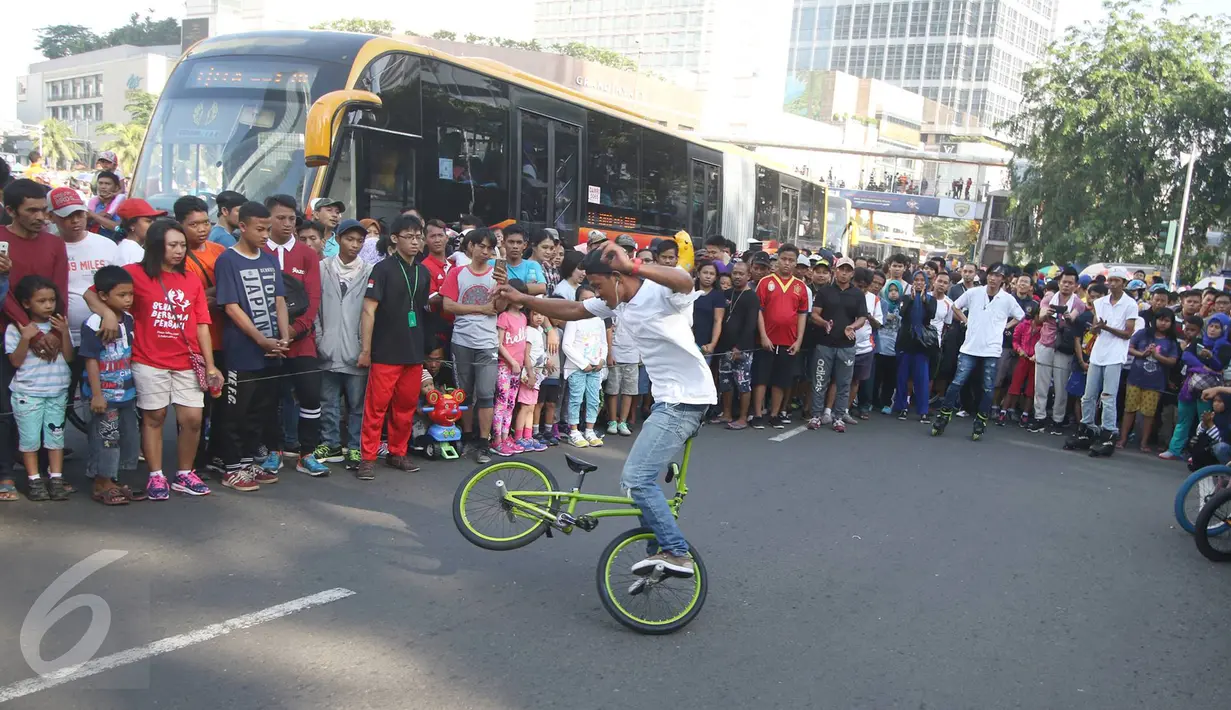 Seorang pria mengendarai sepeda melakukan gaya bebas saat unjuk kebolehan saat pelaksanaan HBKB di Jakarta, Minggu (12/3). (Liputan6.com/Immanuel Antonius)