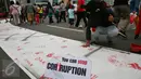 Aksi jelang peringatan Hari Anti Korupsi Sedunia  9 Desember  yang dilakukan BEM UI ini mengajak warga untuk berpartisipasi dalam gerakan nasional memberantas korupsi, Jakarta, Minggu (27/11). (Liputan6.com/Johan Tallo) 
