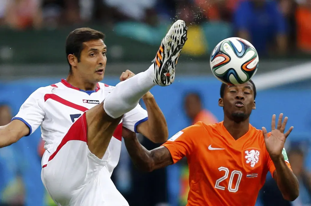 Gelandang Timnas Kosta Rika, Celso Borges (kiri), berusaha merebut bola dari Georginio Wijnaldum (Belanda) saat berlaga di perempat final Piala Dunia 2014 di Stadion Fonte Nova, Salvador, (6/7/2014). (REUTERS/Marcos Brindicci)