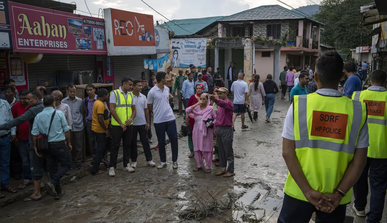 Orang-orang menyaksikan kerusakan yang disebabkan oleh tanah longsor setelah hujan deras di Khaniyara, dekat Dharmsala, India (2/9/2022). Tidak ada korban jiwa yang dilaporkan akibat musibah tersebut. (AP Photo/Ashwini Bhatia)