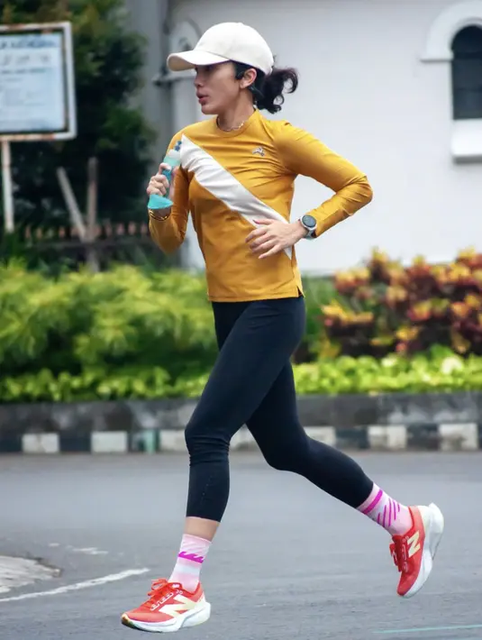 <p>Dengan kaos lari bernuansa kuning, Ussy juga terlihat begitu tekun melakukan olahraga ini. [Foto: Instagram/ Ussy Sulistiawaty]</p>