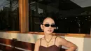 Pada salah satu penampilannya, Mahalini memilih nuansa earthy yang sedang tren. Ia mengenakan tank top cokelat dengan detail tekstur dan bordir yang memberikan sentuhan feminin tanpa terlihat berlebihan. Atasan tersebut dipadukan dengan celana longgar warna krem yang menciptakan siluet santai sekaligus effortless.