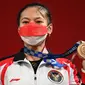 Lifter putri Indonesia Windy Cantika Aisah menunjukkan medali perunggu Olimpiade Tokyo 2020 cabang angkat besi nomor 49 kg di Tokyo International Forum, Sabtu (24/7/2021). Windy Cantika mempersembahkan medali pertama bagi Indonesia yakni perunggu dengan total angkatan 194 Kg. (Vincenzo PINTO/AFP)