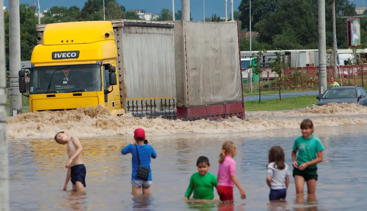 Sebuah truk melintas di jalan banjir di Minsk, Belarus, Rabu (13/7). (REUTERS / Vasily Fedosenko)